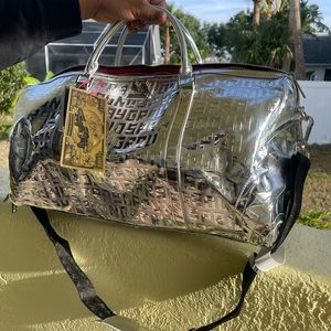 This is a brand new silver Sprayground duffle bag